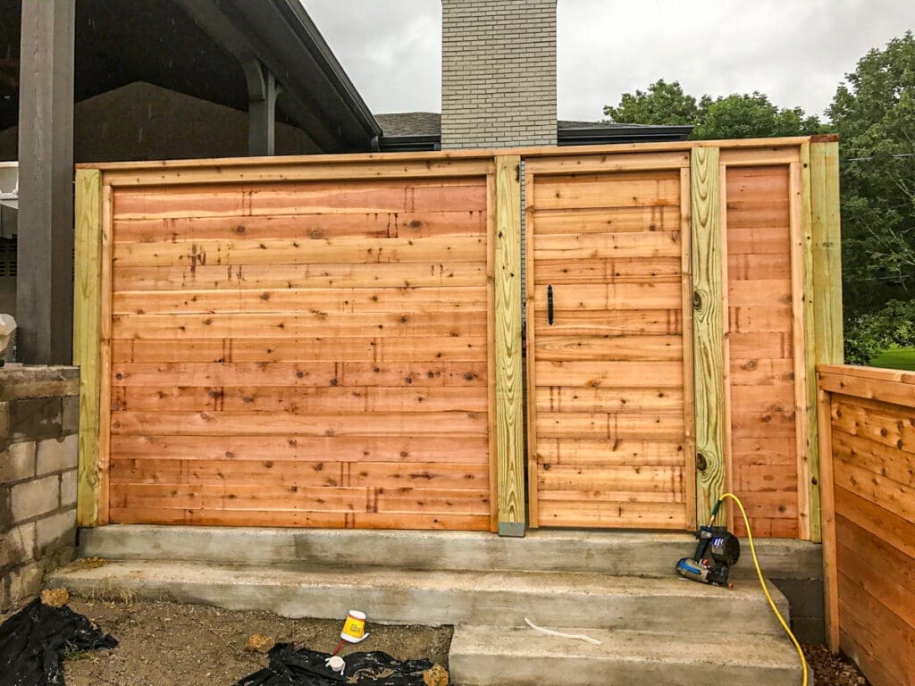 Wood privacy fence with a side gate, showcasing quality craftsmanship and design, ideal for enhancing outdoor spaces in Dickson County, TN.