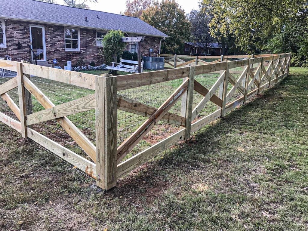 Wooden privacy fence installation in a residential yard, showcasing sturdy construction and craftsmanship by Home Deck & Fence in Middle Tennessee.