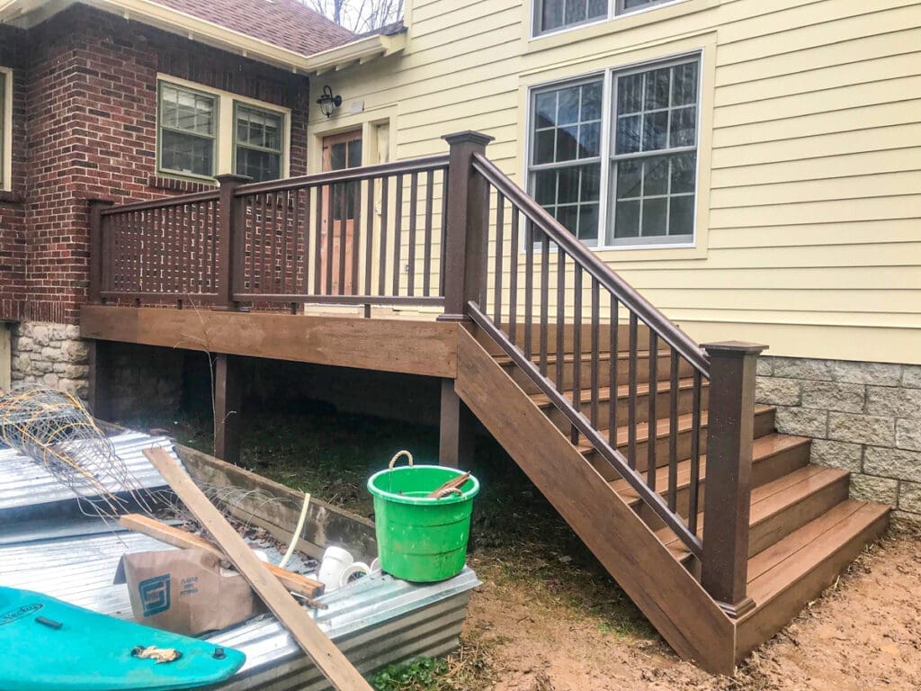 Wooden deck with railing and stairs leading to a house, showcasing craftsmanship by Home Deck & Fence Co. in Middle Tennessee.