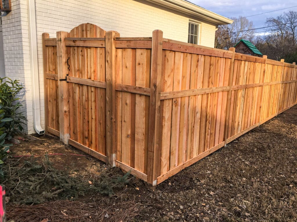 New wooden fence installation with a gate in Dickson, TN, showcasing privacy and security features for homeowners in Middle Tennessee.