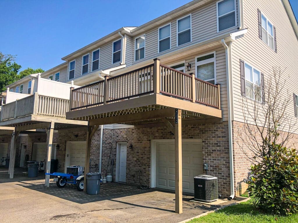 Deck and outdoor space of a residential building in Dickson County, Tennessee, showcasing a wooden deck above a garage area, emphasizing home improvement and maintenance potential.