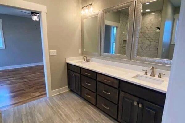 Modern bathroom featuring dual sinks, dark wood cabinetry, and large mirrors, showcasing custom home design by HDF Builders in Middle Tennessee.