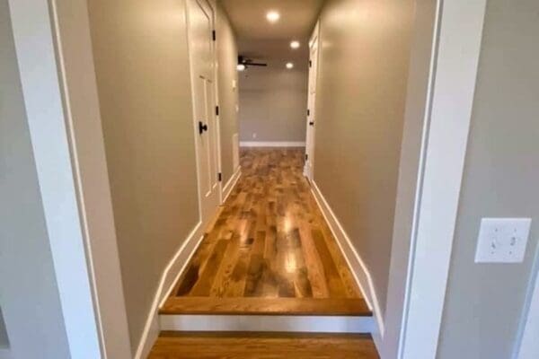 Interior hallway featuring hardwood flooring, neutral walls, and recessed lighting, showcasing custom home design by HDF Builders in Middle Tennessee.